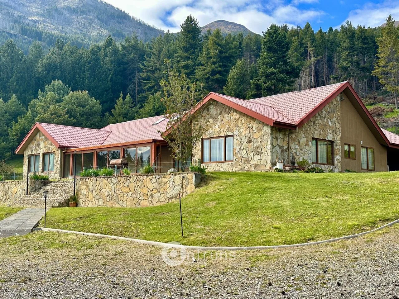 Exterior view of a large house in a residential area of Coyhaique