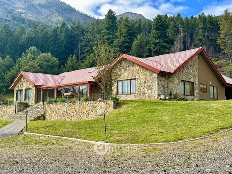Exterior view of a large house in a residential area of Coyhaique