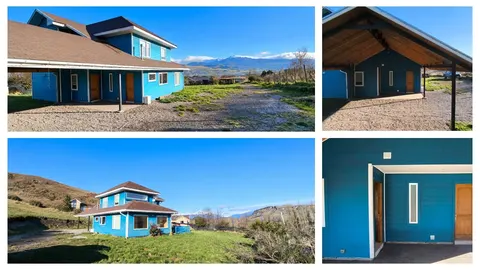 Turquoise house exterior with mountain backdrop