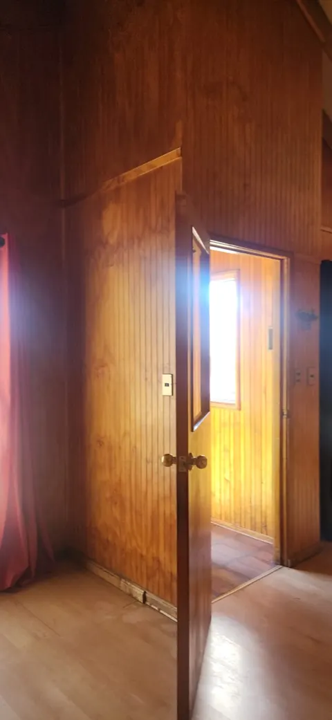 Master bedroom with window and closet in Coyhaique