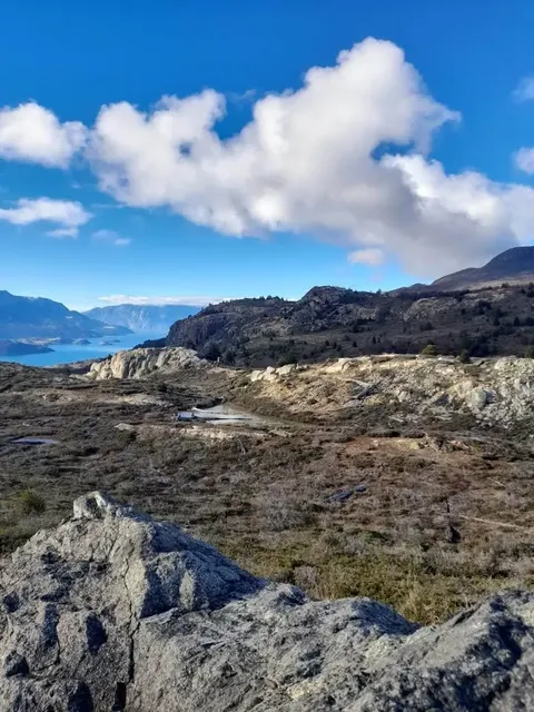 A dirt path leading into a vast rural landscape in Patagonia