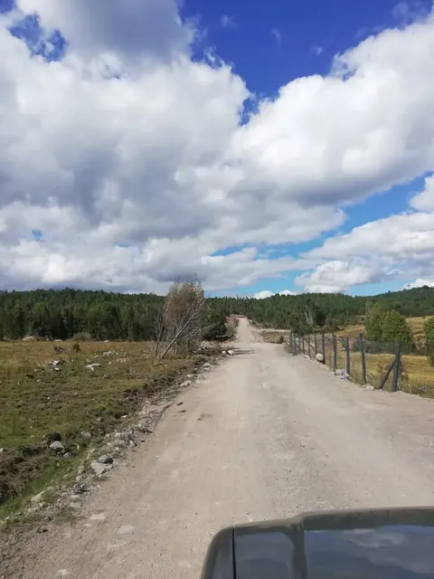 Open field on the parcel with mountains in the background